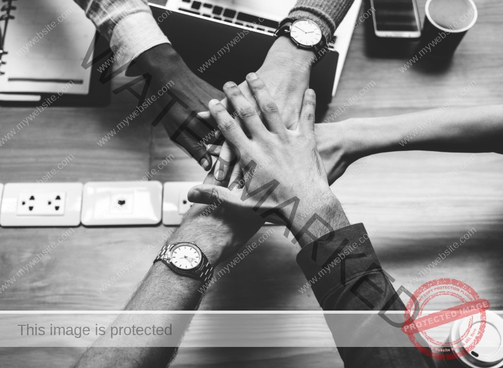 Team of business people stacking hands